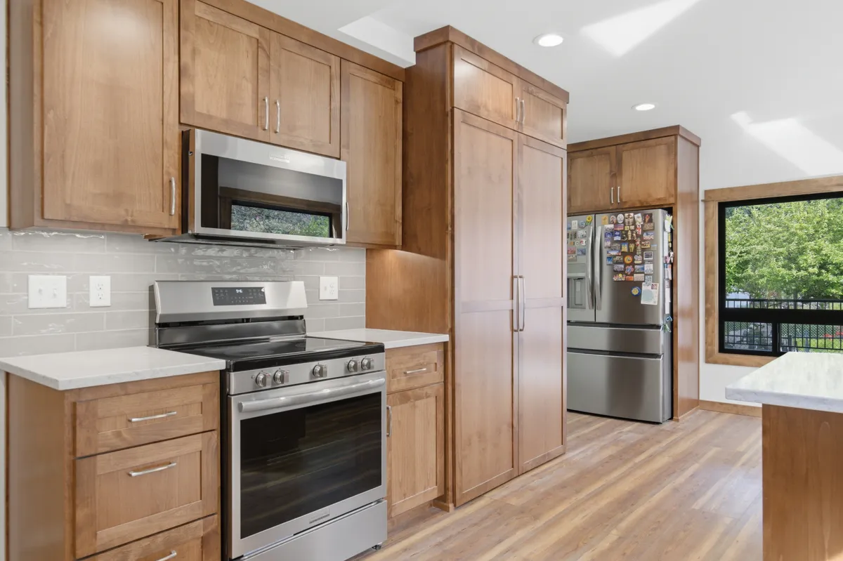 Tall pantry cabinets beside the range